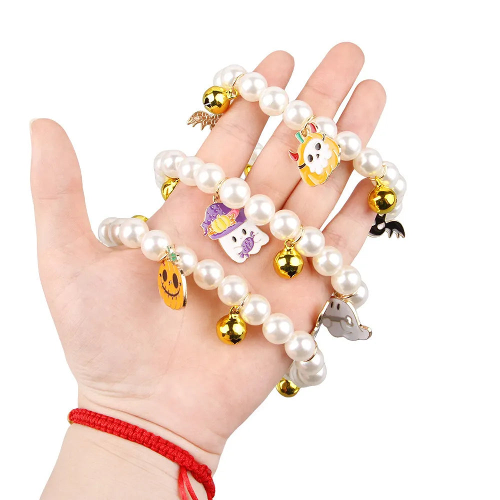 Halloween decorative pet collar with simulated pearls and a pumpkin charm.