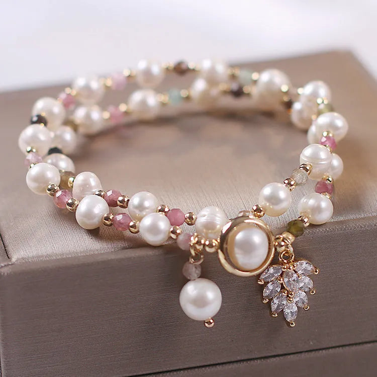 Red double-layer crystal bracelet with Lucky Cat charm and floral beads on wrist
