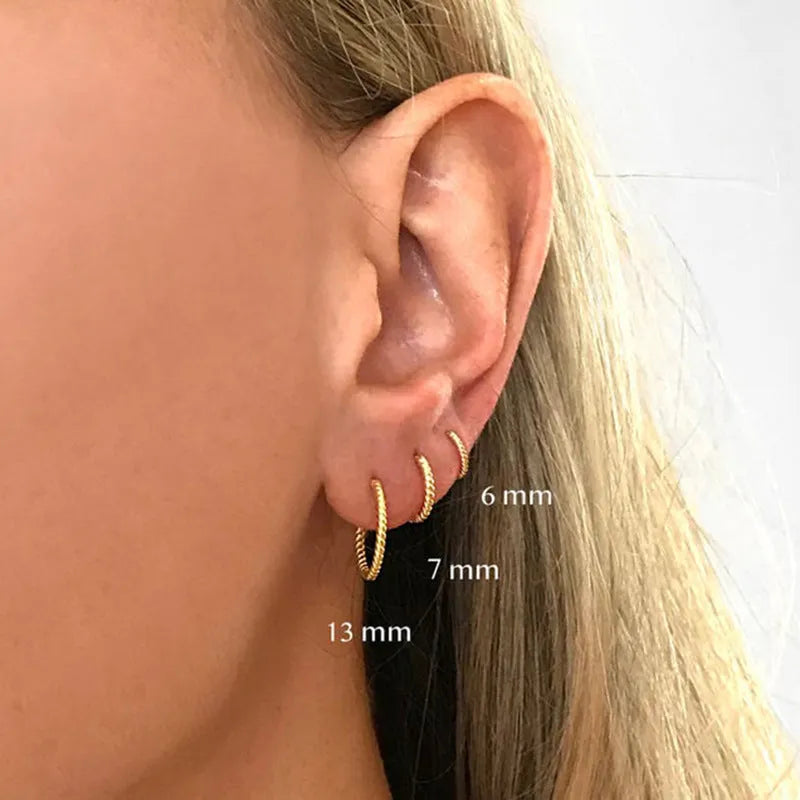 Twisted sterling silver round ring earrings in golden and white gold finishes