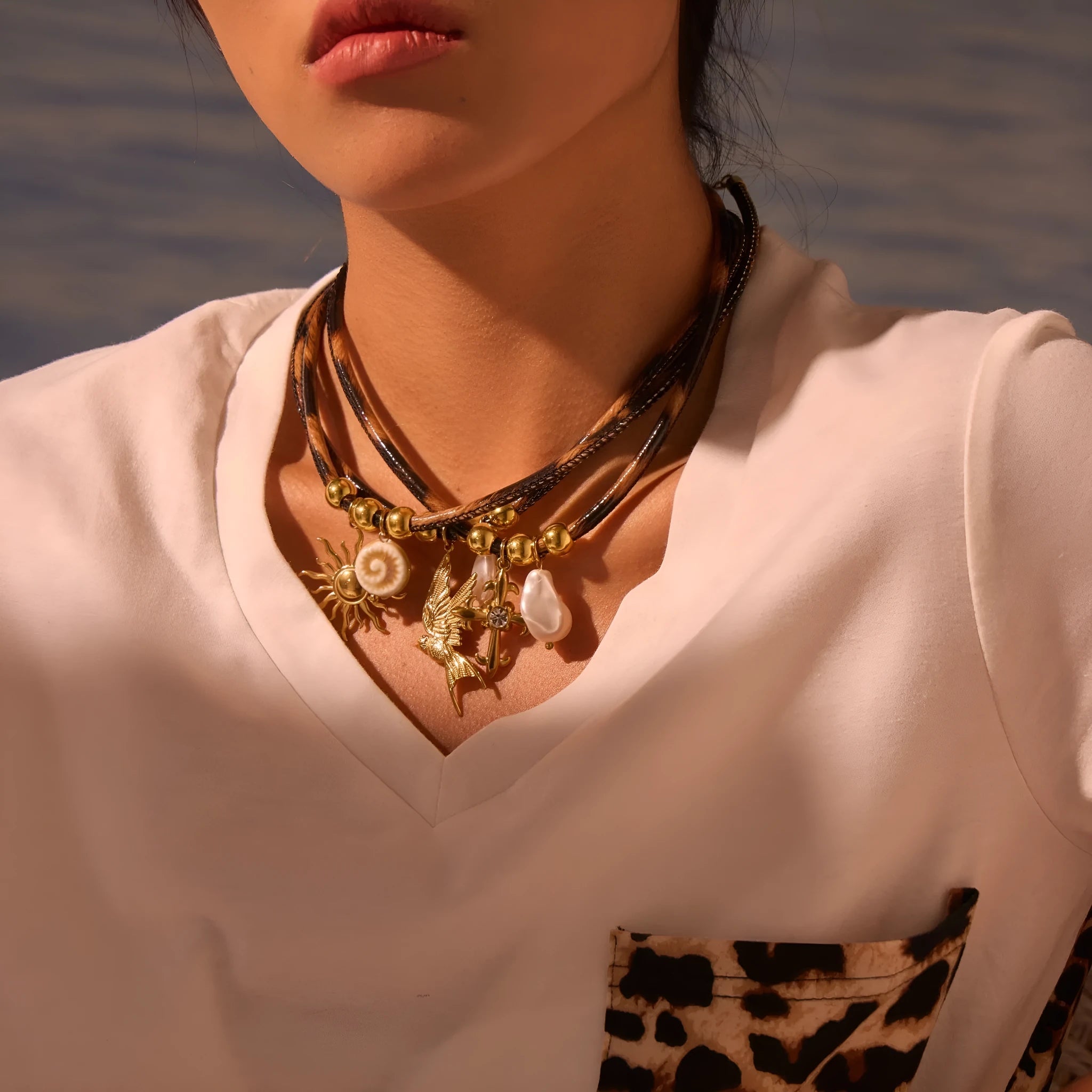 Geometric leopard pendant necklace on a stainless steel chain with adjustable length between 41cm and 50cm.