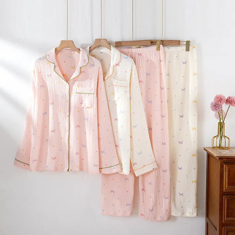 Women's long-sleeved cotton pyjama set in pink, showing top and trousers laid flat
