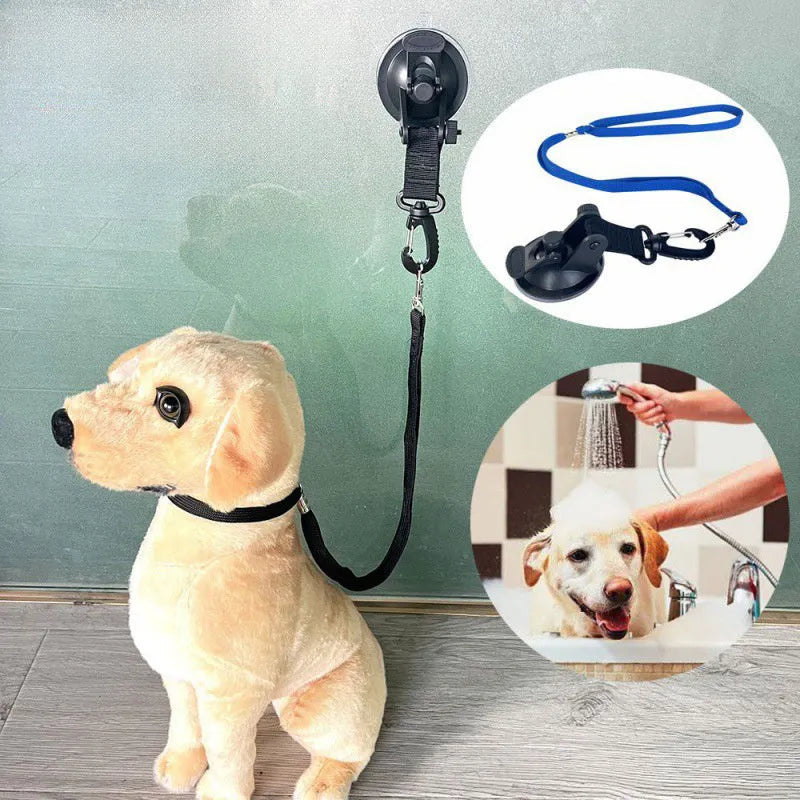 Black pet bathing restraint with four suction cups, a traction rope, and anti-bite handcuffs on a tiled wall.