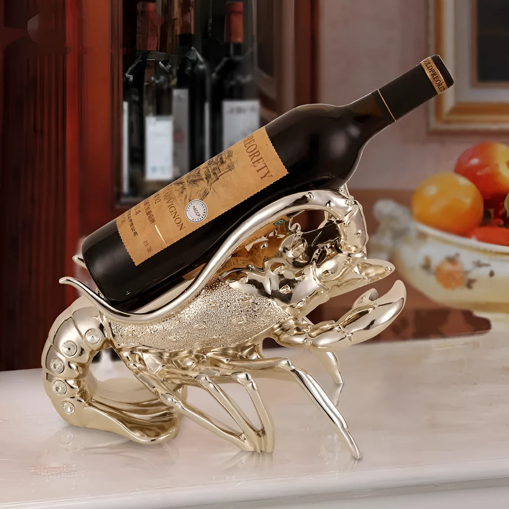 Metallic rose gold lobster-shaped resin ornament holding a wine bottle.