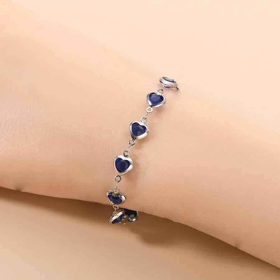 Devil's Eye geometric heart-shaped stainless steel bracelet in one of six colour options on a wrist.