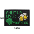 Embroidered fabric badge with Velcro backing showing detailed clover leaf pattern in green thread