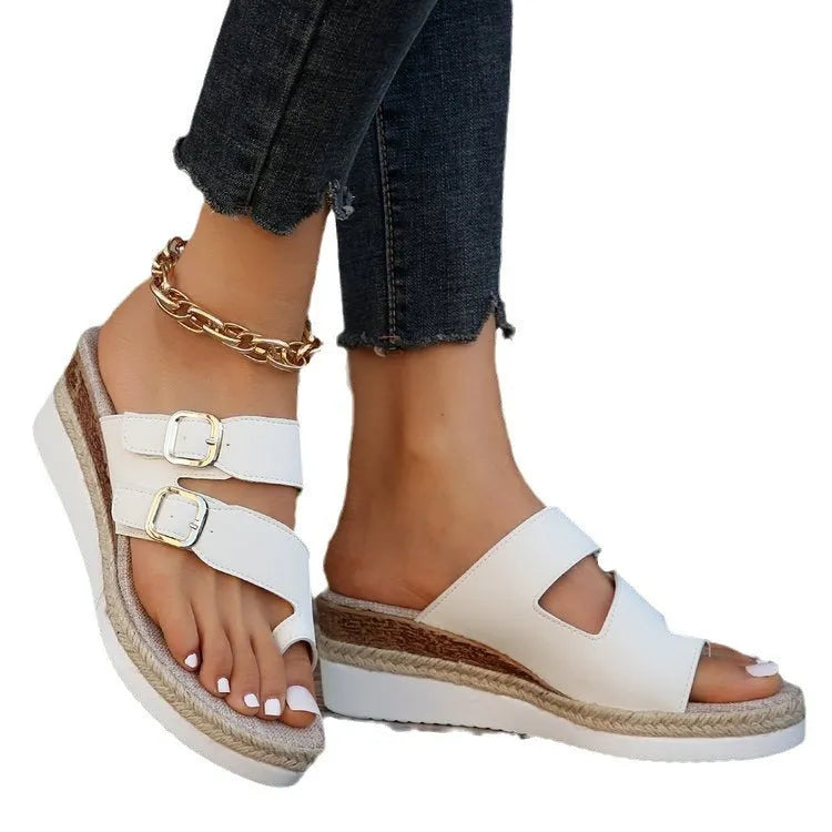White women's wedge sandals with woven patent leather upper and peep toe.