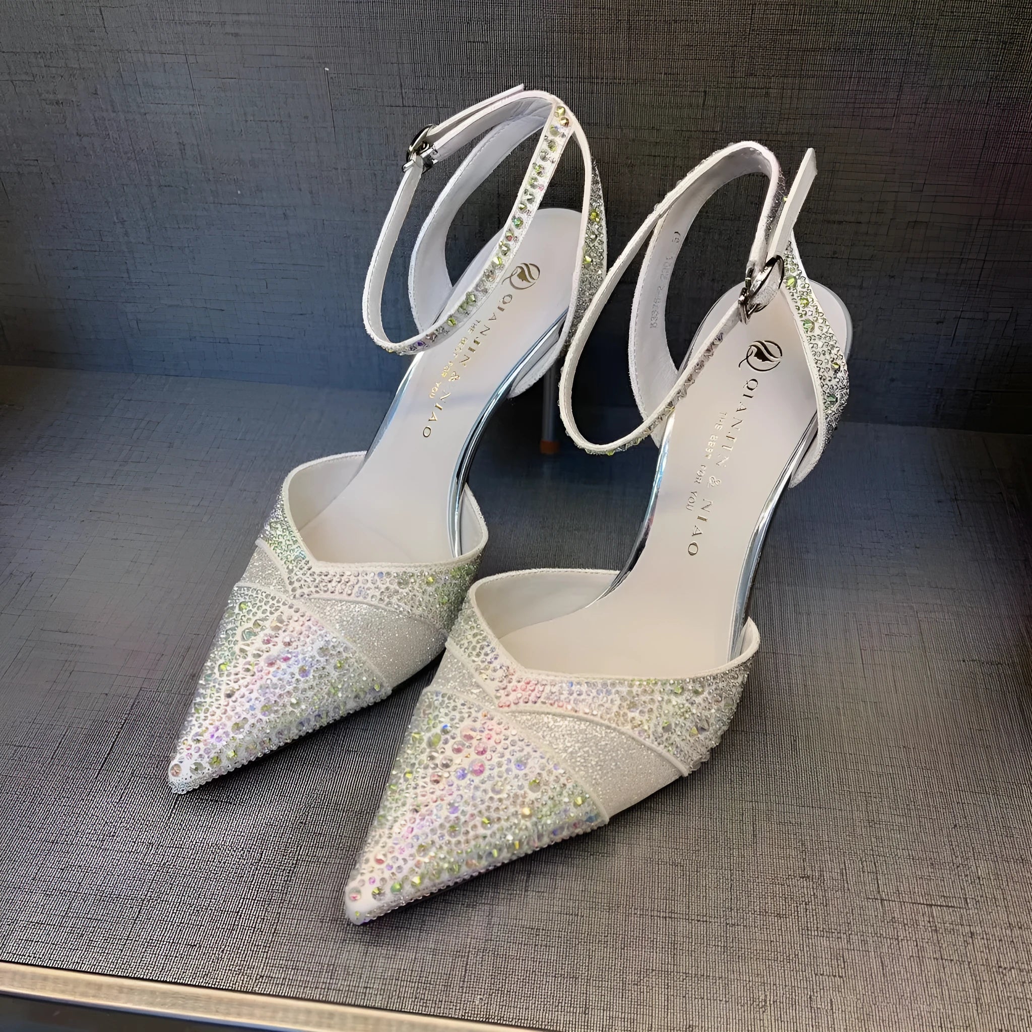 Women's hollow stiletto high heels with red sole and pointed toe design in black and silver options