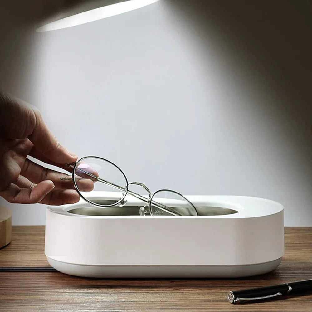 White portable ultrasonic cleaning machine with stainless steel tank for jewellery and glasses.