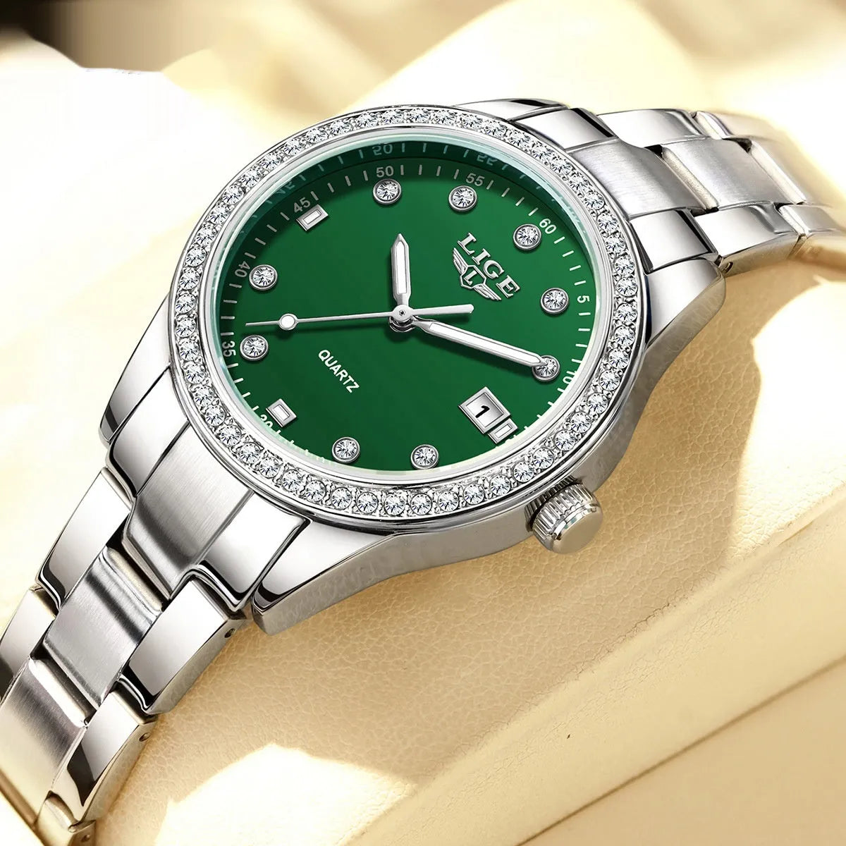 Silver fashion quartz watch for women with diamond-encrusted bezel and luminous dial on a 34mm stainless steel case.