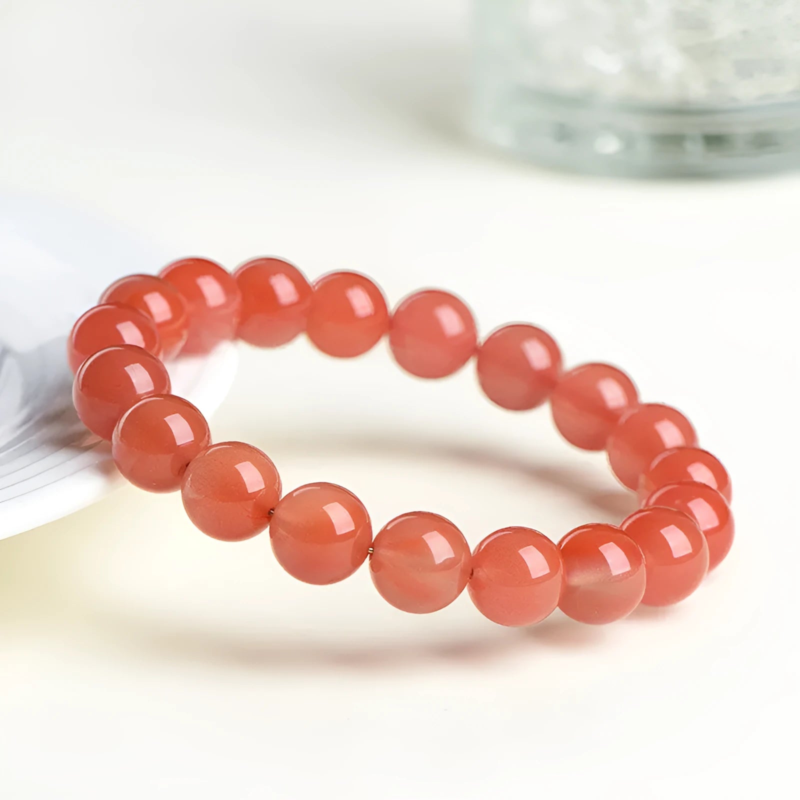 Natural Cherry Red Agate bracelet with polished beads, shown in a single circle configuration.