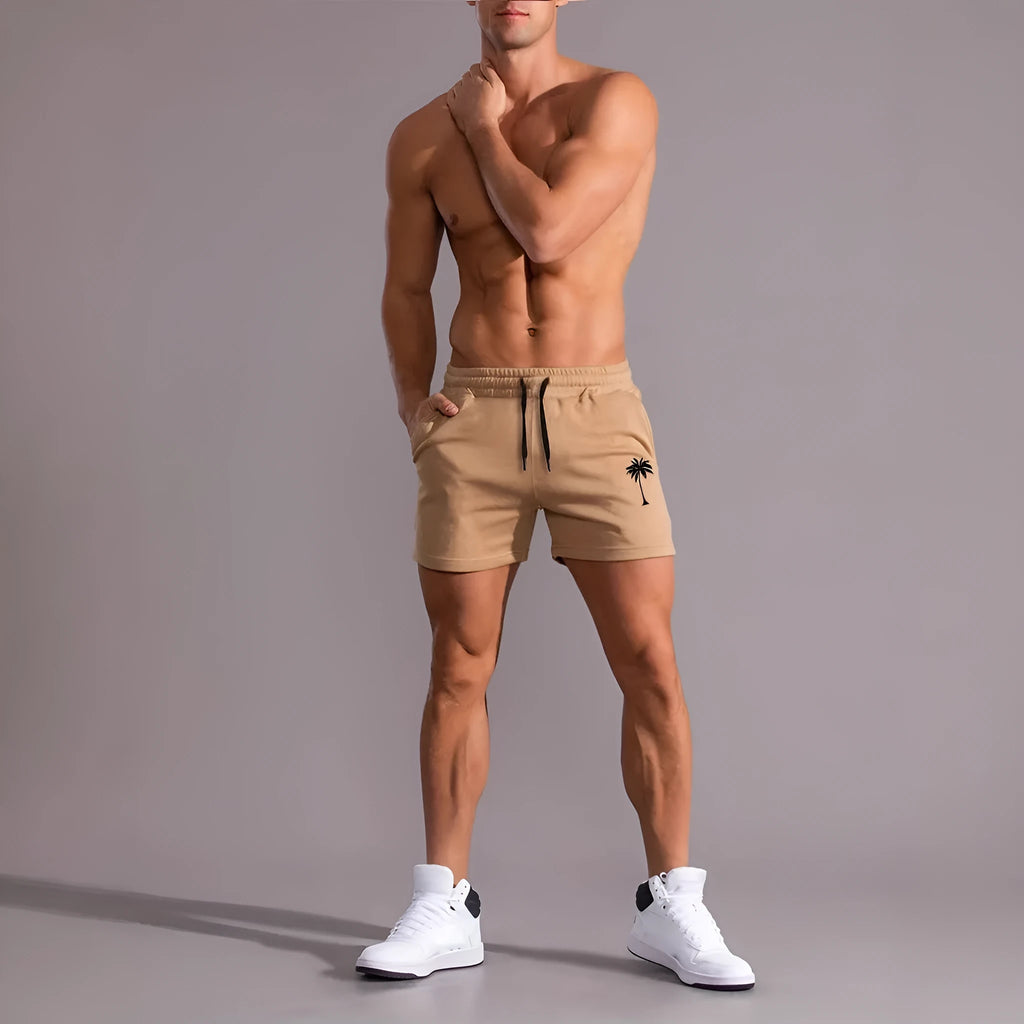 A pair of khaki men's casual shorts featuring a coconut print, shown in a straight-leg sports style.