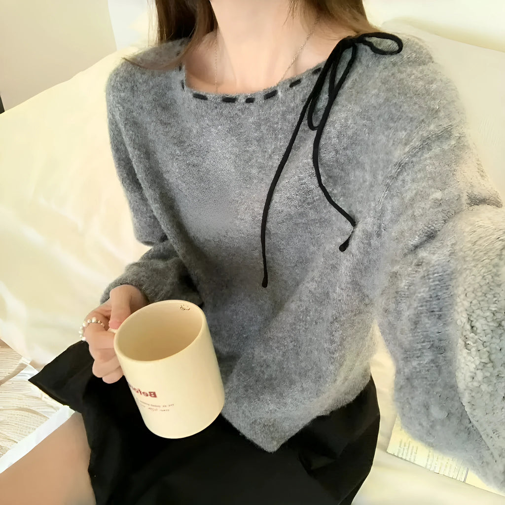 Women's loose grey knitwear pullover showing front view and relaxed fit
