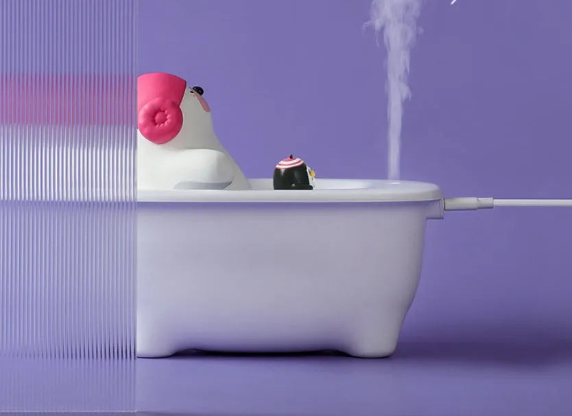 White USB air humidifier with large water tank on a desk.