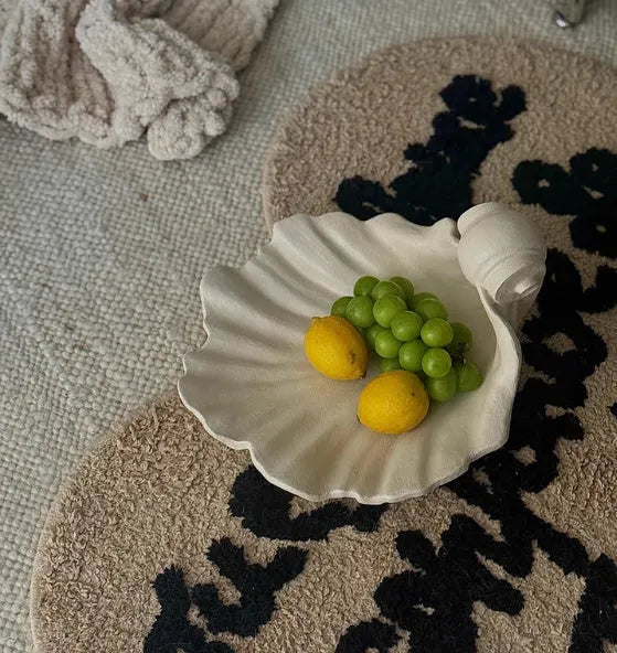 White resin decorative shell ornament for use as a fruit plate or table centrepiece.
