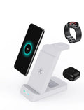 Black and white 65W three-in-one wireless charging dock for iPhone, Samsung, AirPods, and iWatch on a desk.