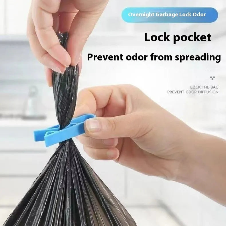 A white polypropylene plastic clip for holding bin bags onto the side of a rubbish bin.