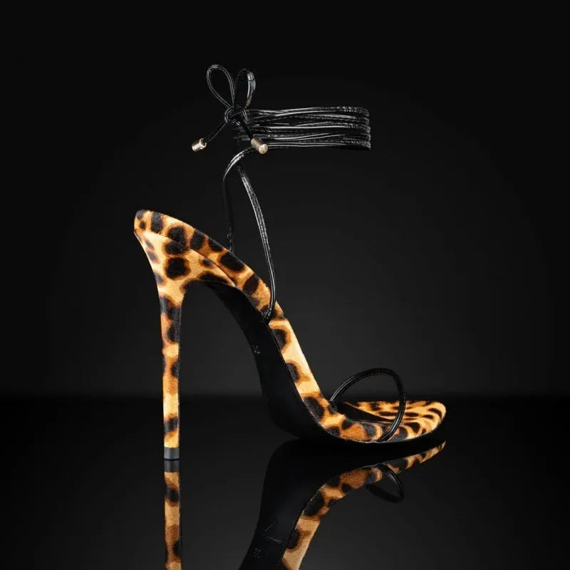 Women's leopard print pointed toe sandals with Roman lace-up straps and buckle fastening.