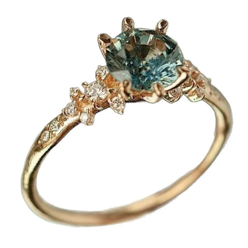 Gold plated geometric ring with claw-set zircon stone and chamfered square pattern design