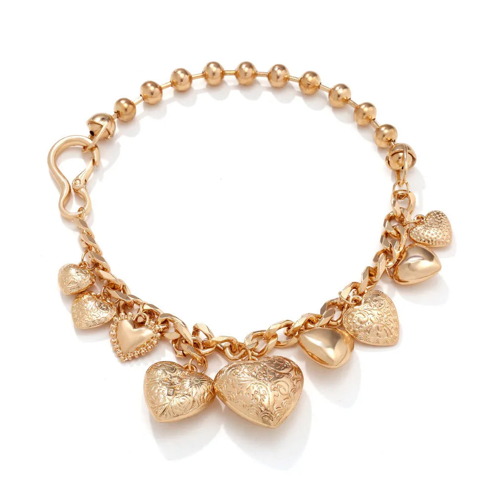 Carved heart pendant necklace in gold finish with exaggerated style on metal chain