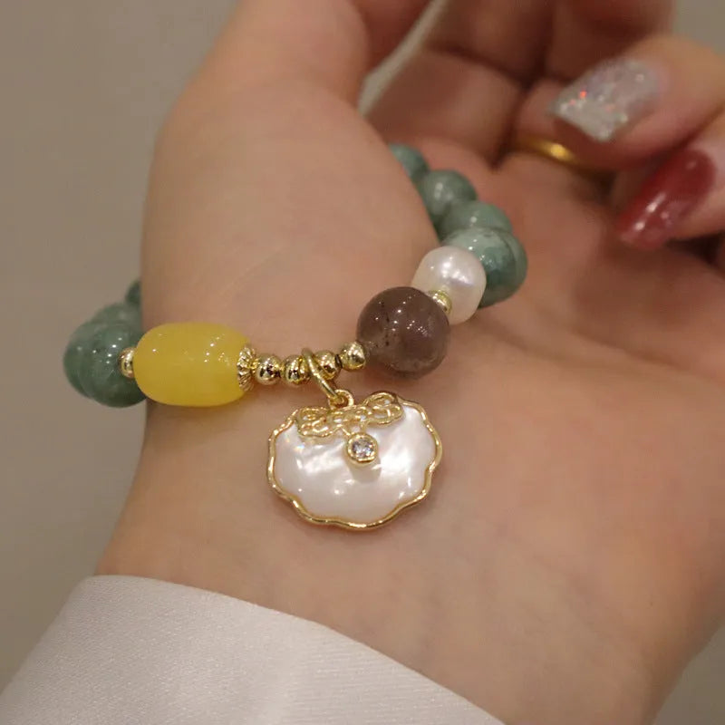 Women's fashion bracelet made from natural green jade shells on a casual background