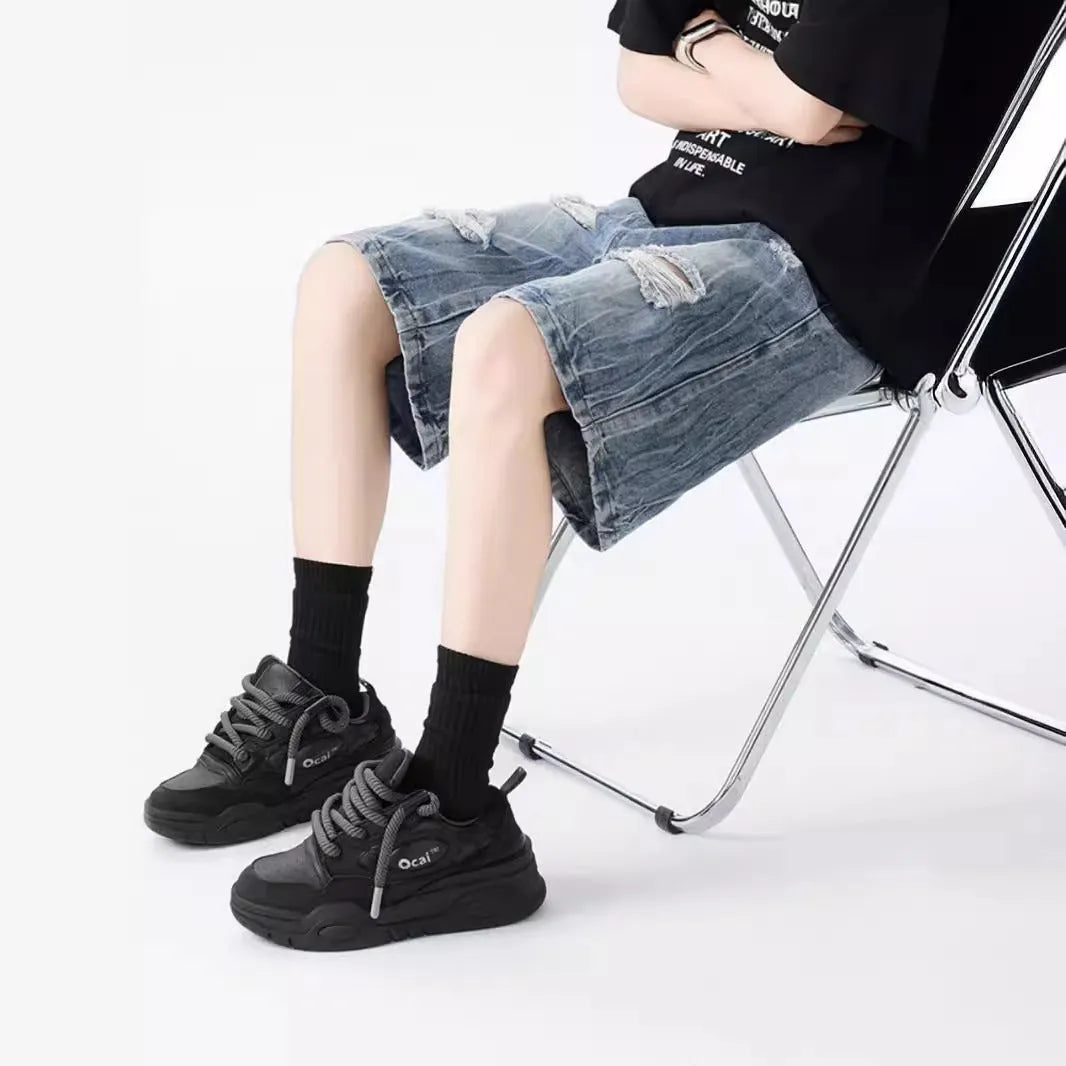 Man's washed blue denim shorts with ripped details and a loose, retro fit.