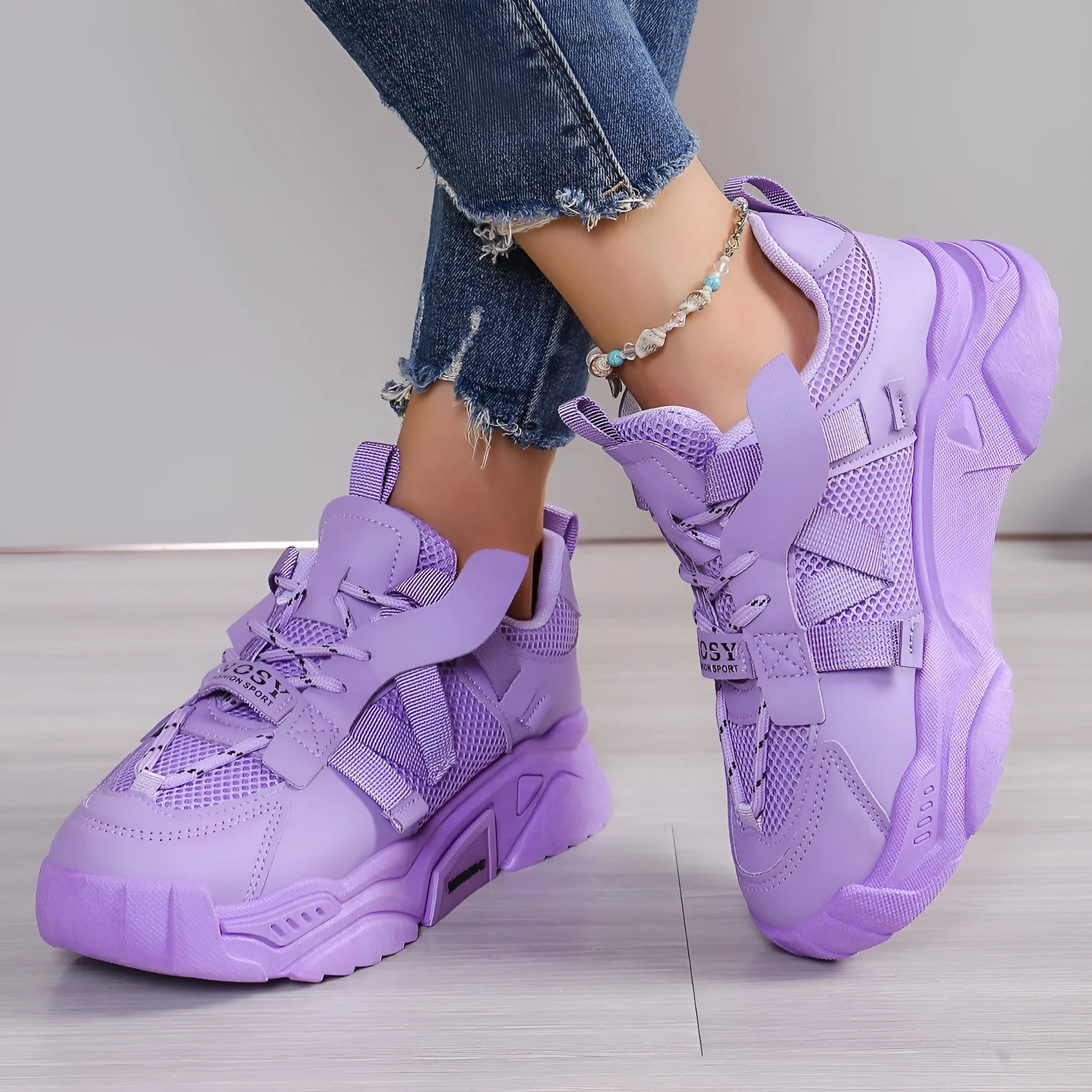 Women's purple platform mesh sports trainer with lace-up front on a white background.