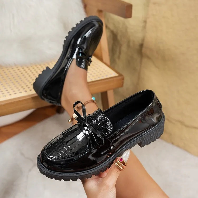 Women's brown loafer shoe with a decorative bow on the artificial PU upper.