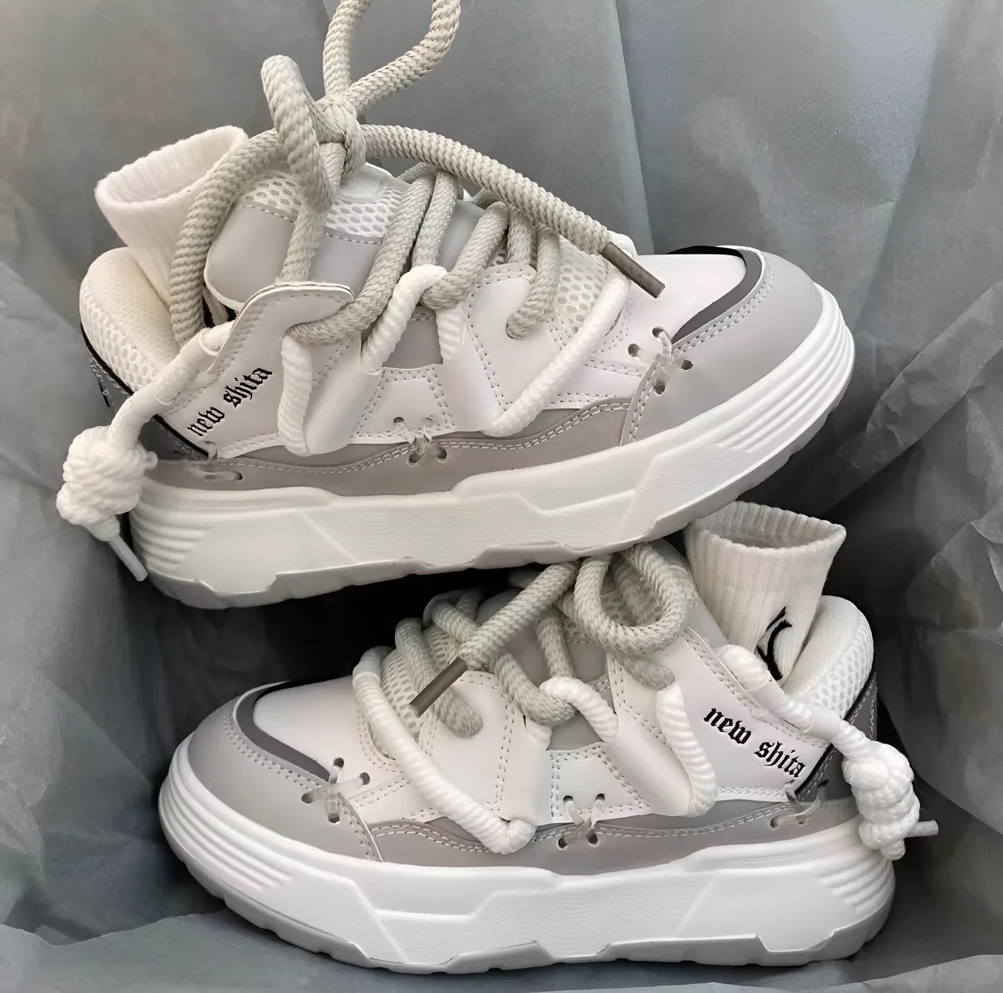 Women's grey retro chunky sneakers with thick rubber sole and high heel on a plain background