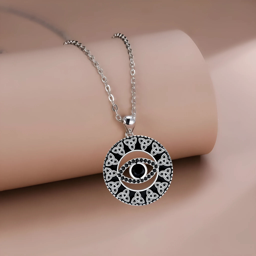 Close-up of a copper Devil's Eye pendant necklace on a cross chain for women.