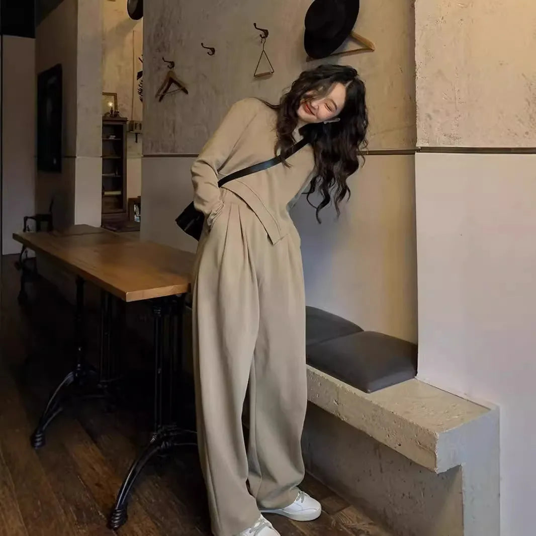 Women's khaki casual sports suit set with long sleeve top and matching trousers on a hanger.