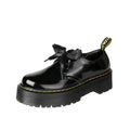 Black and white thick soled women's lace-up shoes with cross straps on a superfine fibre upper.