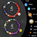 Two natural stone zodiac bracelets with adjustable strings on wooden surface