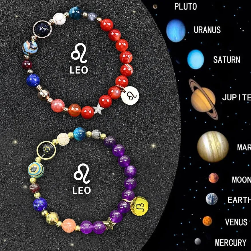 Two natural stone zodiac bracelets with adjustable strings on wooden surface