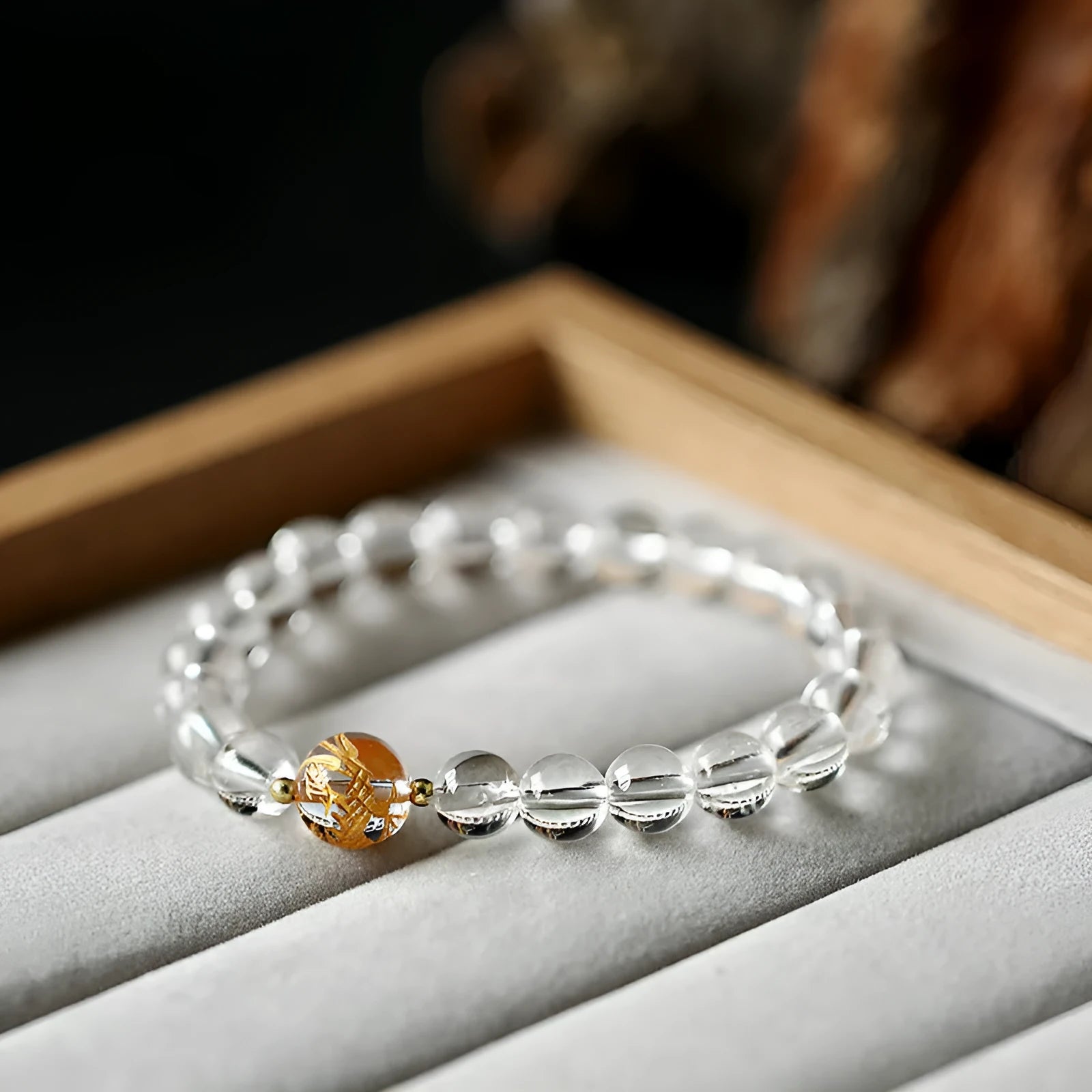 Geometric obsidian white crystal bracelet with black agate beads and gold dragon charm on wrist