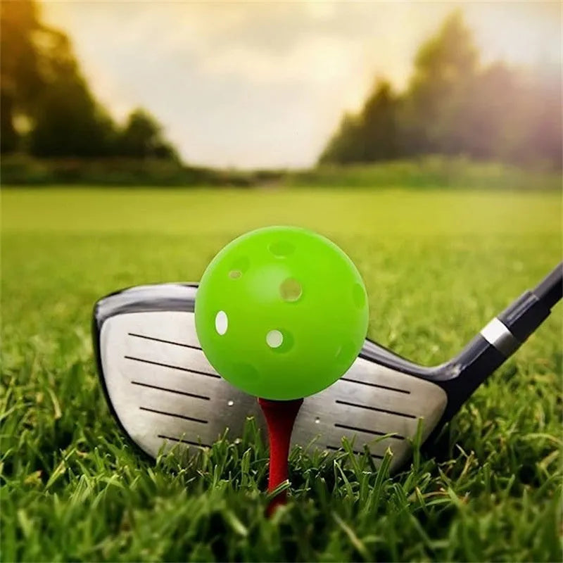Multi-colour golf practice balls with 26-hole design including red, orange, blue, green, white and yellow