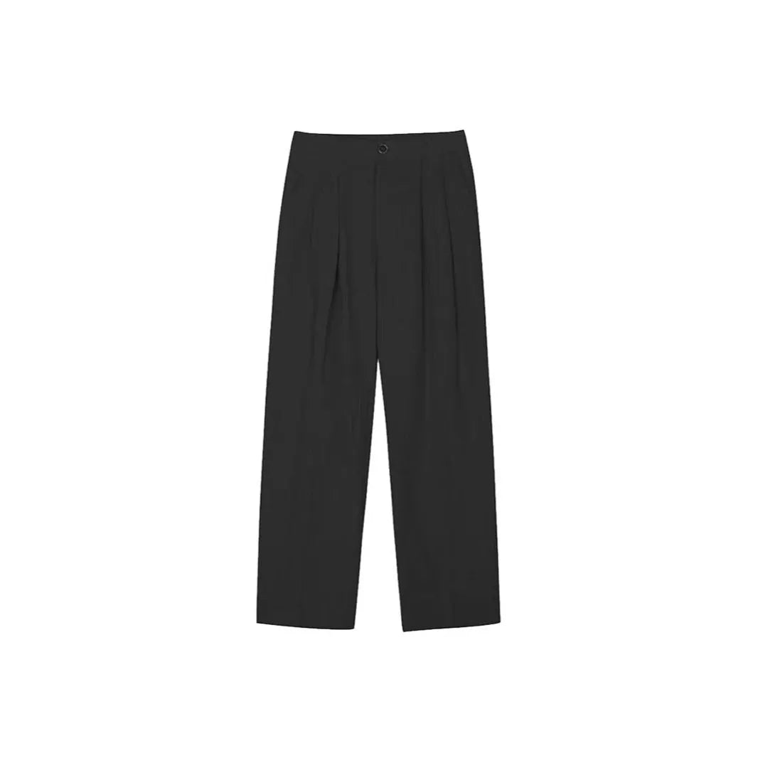 Men's apricot coloured loose-fit cotton linen trousers with a pencil leg and elastic waist on a neutral background.