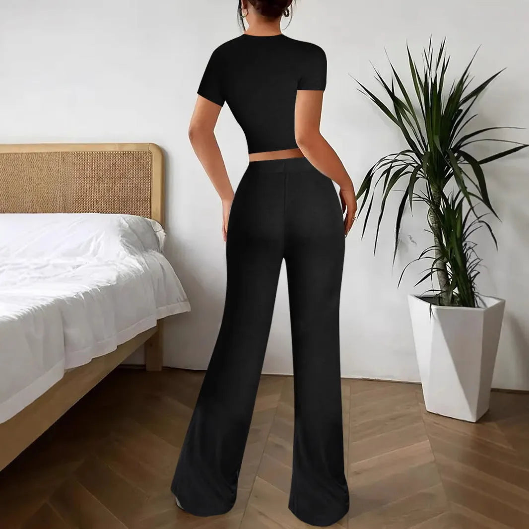 Black women's high waist trouser and short sleeve t-shirt co-ord set on a hanger.