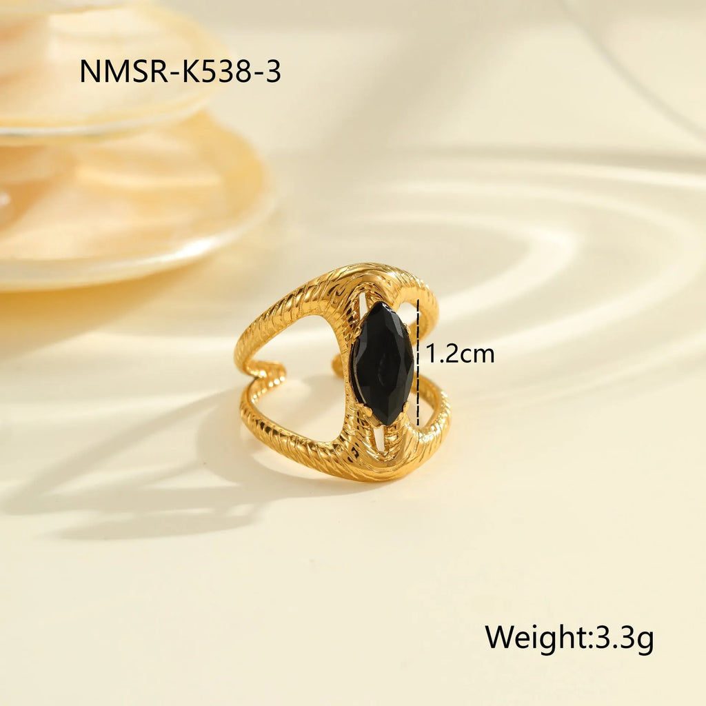Geometric open-mouth stainless steel ring for women with inlaid zircon stones on a grey background.
