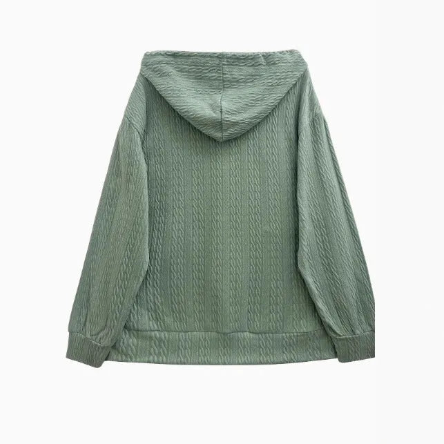 Green loose-fit women's hooded sweater coat with a front zipper and long sleeves on a hanger.