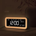 Blue rectangular LED atmosphere light alarm clock with digital display on bedside table