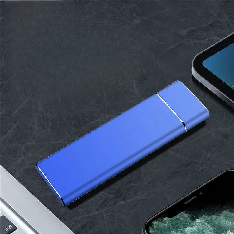 Sapphire blue portable external SSD drive with metal housing next to USB cable