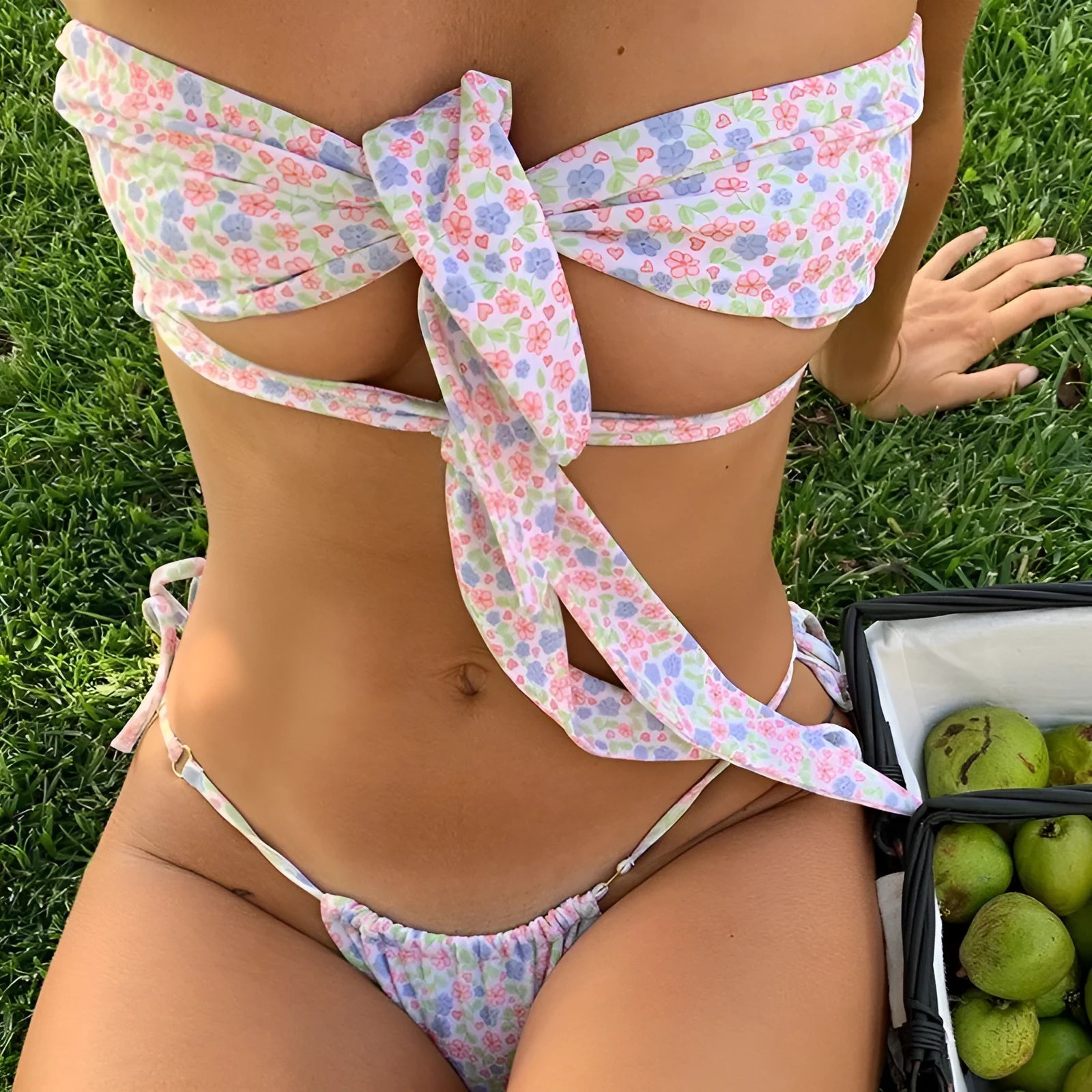 Women's lace-up split swimsuit with built-in chest pad in a floral print