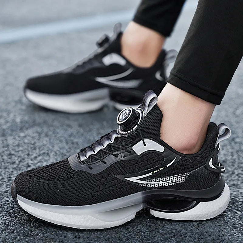Men's white low-top running shoes with a rotating button buckle and round toe on a gray background.