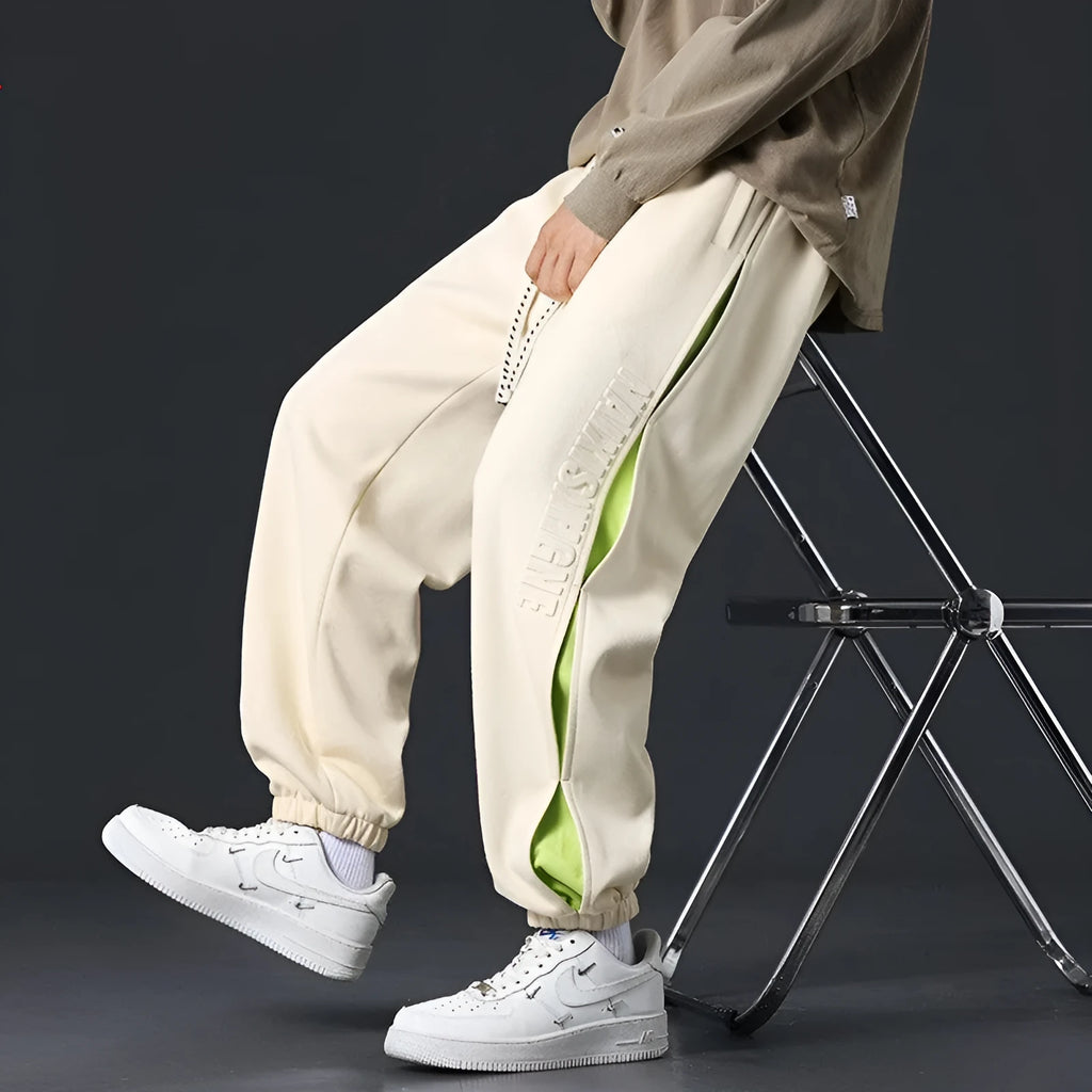 Men's loose fit cotton trousers with banded ankle and collage stitching detail in grey green