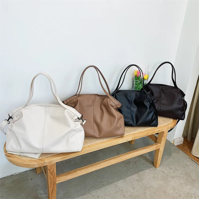Large soft surface messenger bag in horizontal square shape with adjustable shoulder strap