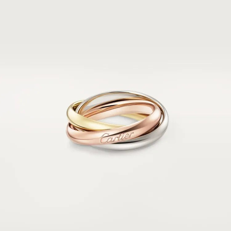 Set of three geometric U-shaped silver couple rings with diamond accents on a grey background.