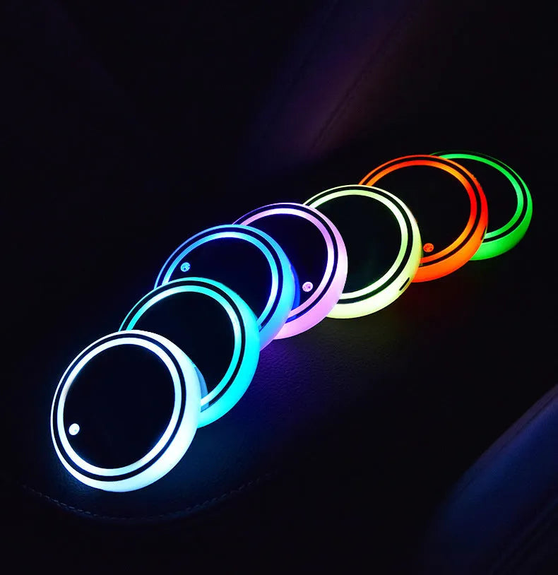 Colourful LED light-up coaster for car cup holder showing seven changeable colours and USB cable.