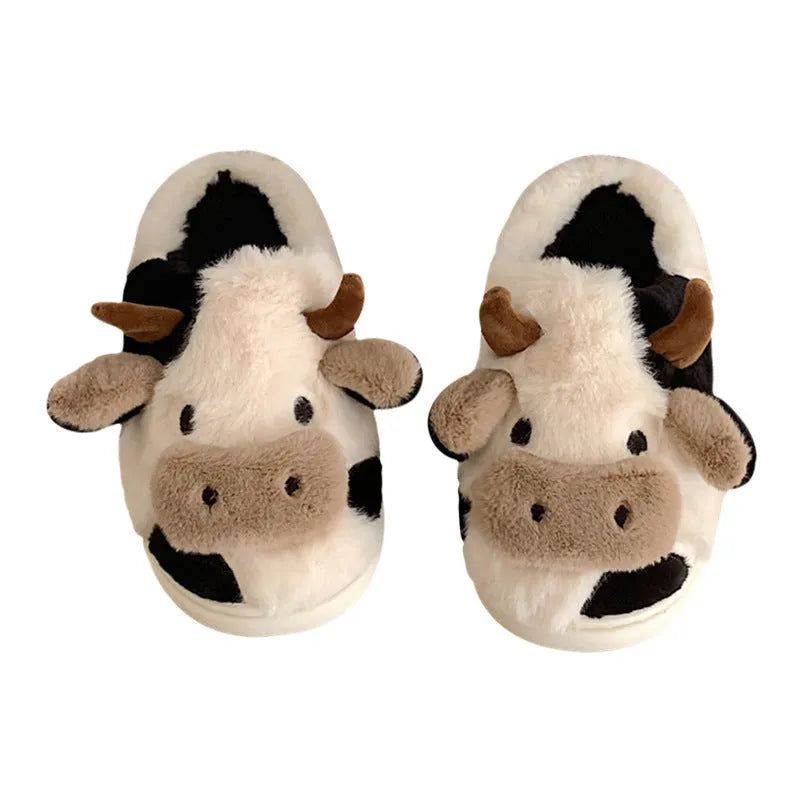 White cow-themed plush slippers for women with a non-slip textured sole.