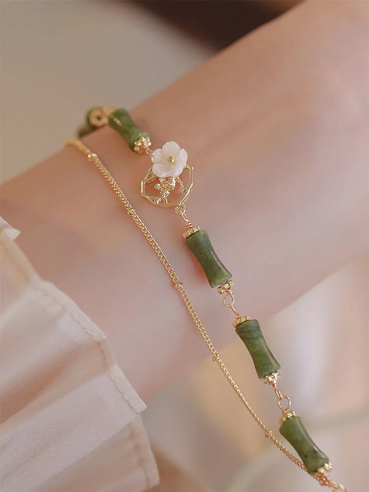 Handmade natural olivine women's bracelet with Chinese double layer twin bells and an olive branch design.