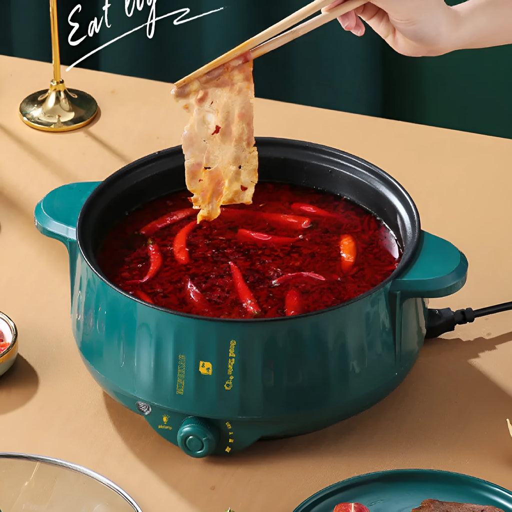 White stainless steel electric hot pot with non-stick interior on a kitchen countertop.